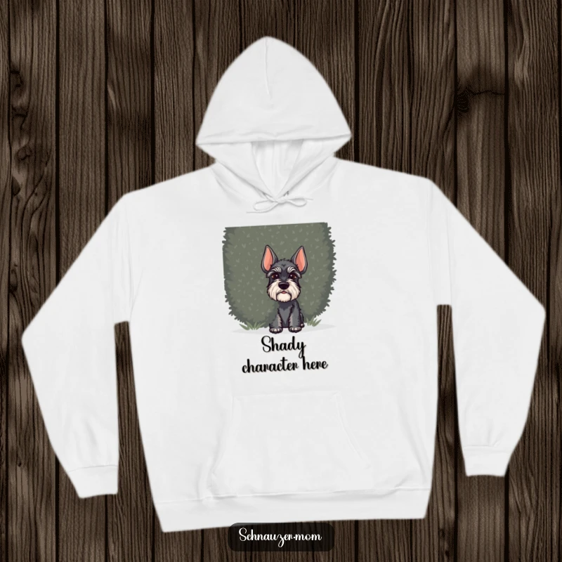 Funny Schnauzer dog hoodie, depicting a dog peeking out from behind a thick bush, radiating curiosity and playful secrecy.