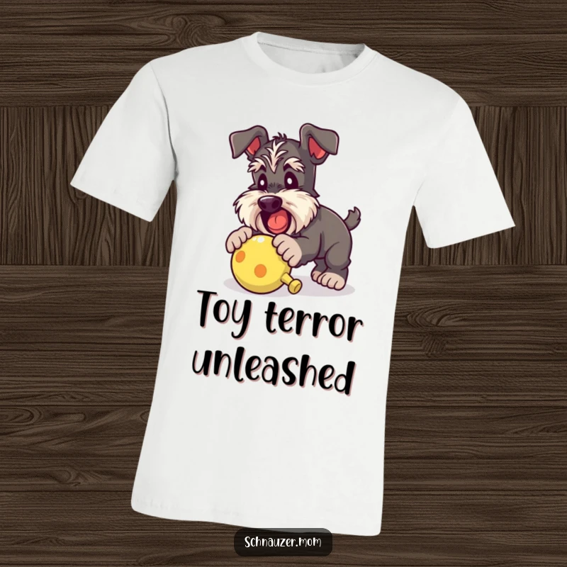 Funny Schnauzer lady t-shirt featuring a dog mid-pounce, energetically attacking a squeaky toy with sheer delight and playful abandon.