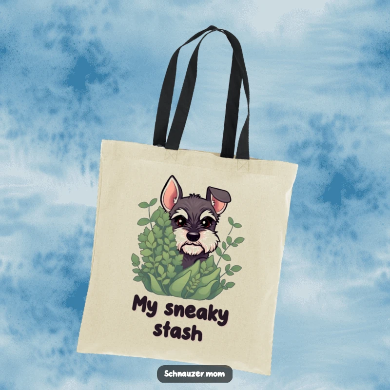 Funny Schnauzer tote bag showcasing a dog peeking out from greenery with a mischievous glint, perfect for carrying secrets.