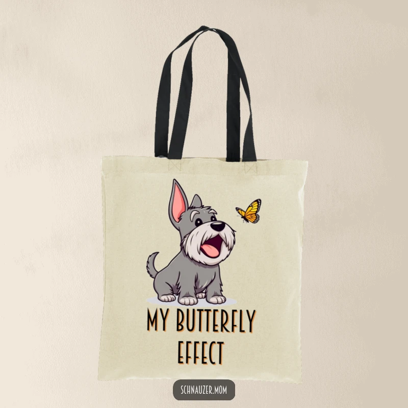 Funny Schnauzer tote bag depicting an excited dog character joyfully barking at a butterfly, symbolizing pure delight.